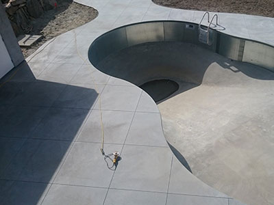 Saw cutting control joints into a concrete slab